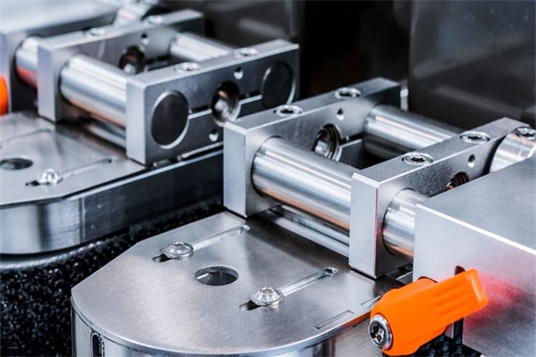 Fragment of the conveyor of the pharmaceutical labeling machine. Abstract industrial background.