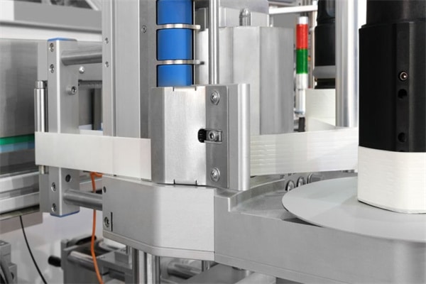 Fragment of the conveyor of sticking labeling machine. Abstract industrial background.